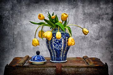 Vase bleu de Delft avec tulipes jaunes sur coffre vintagem I sur marlika art