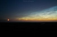 The moon photographed with luminous night clouds