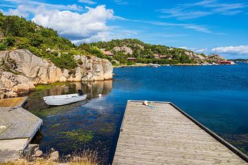 Boat and jetty in Farestad village in Norway by Rico Ködder