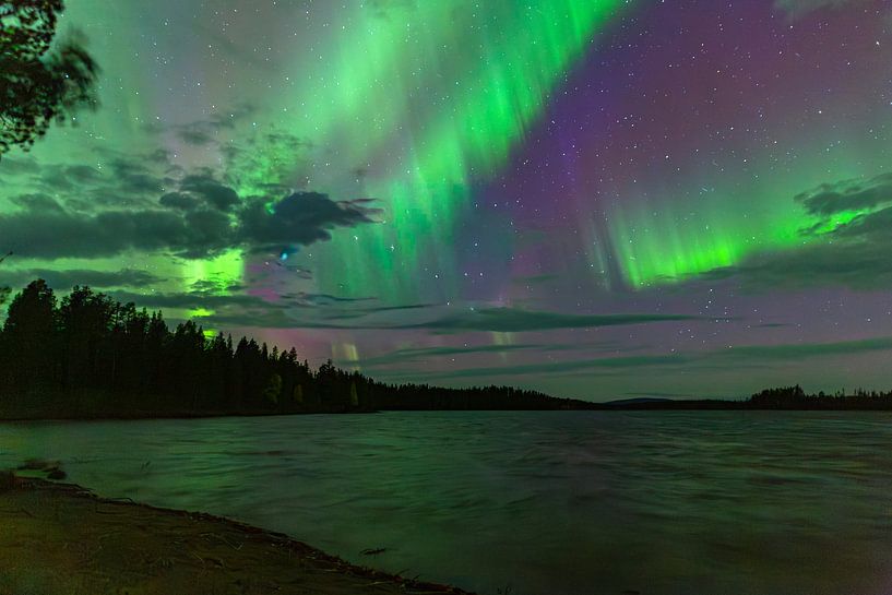 Magical Northern Lights over the lake at the Blueberry Hut in Sweden by Fototante