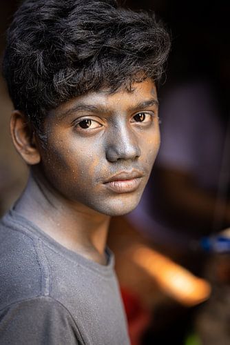 Portrait of a young boy working in a factory
