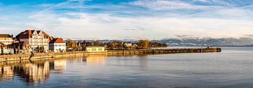 Panorama reflection Langenargen in Lake Constance and Swiss Alps in winter Germany