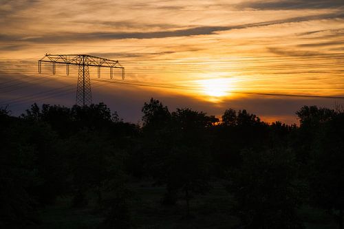 High-voltage pylon with overhead line in landscape