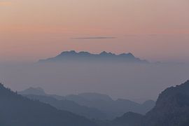 Mountain top rising out of the fog. by Johan Zwarthoed