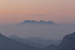Mountain top rising out of the fog.