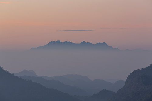 Mountain top rising out of the fog.