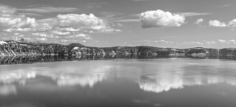 Clouds reflecting in a mountain lake in black and white by Jonathan Vandevoorde