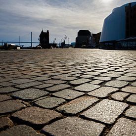 Cobblestones of the Stralsund waterfront promenade against the light