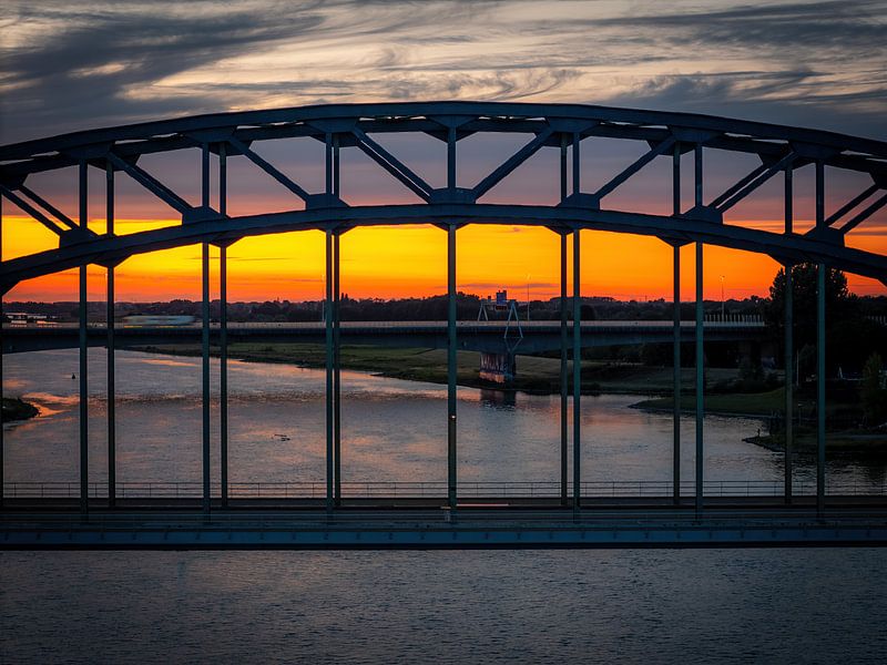 IJssel bridge at sunset - Zwolle in silhouette by Thomas Bartelds