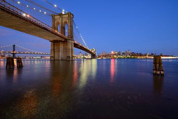Brooklyn Bridge in New York over the East River in the evening by Merijn van der Vliet