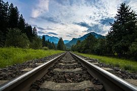 Rail tracks in Austria with mountains by Wilco Bos