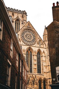 The Gothic façade of York Minster amidst the historic streets of York