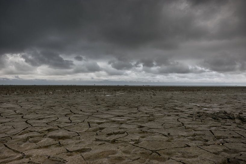 Threatening sky over the Wadden Sea at low tide near Moddergat by Patrick Verhoef
