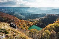 View of a mountain lake amid autumn colours in the Vosges mountains