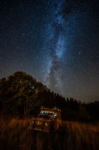 Galaxy above Illuminated Land Rover by Leon Okkenburg