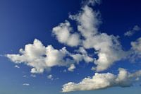 Fluffy white clouds in a blue sky