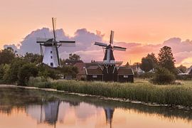 The golden hour at the two windmills in Ten Boer, in the province of Groningen by Marga Vroom