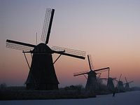 Mill with a lonely skater in Kinderdijk Holland