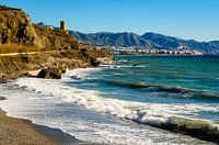 Coast road with mountains and lighthouse at coast near Nerja Andalucia Spain