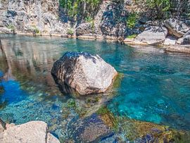 Lonely Rock In The Brilliant Turquoise Coloured Flowing River by Nature Life Ambience