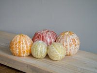 Variation on fruit still life, with peeled citrus fruit.