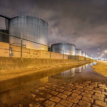 Large silos reflected in a water pond by Tony Vingerhoets