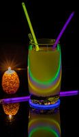 Cocktail with neon lights and candlelight