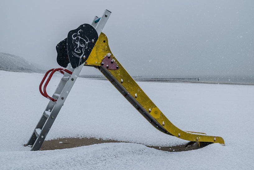 Lonely slider on the snowy beach of Zoutelande by Wouter Pinkhof