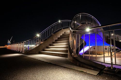 Futuristic illuminated public works with stairs, pedestrian path and train viaduct