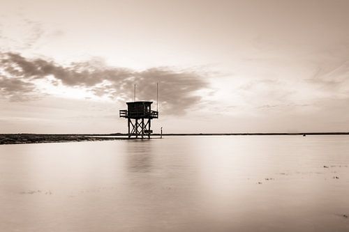 Watch tower in the water in sepia