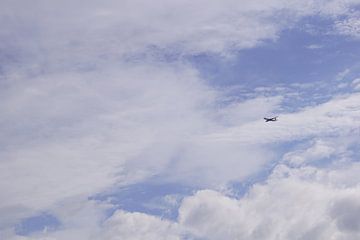 Plane in the cloudy sky by Babetts Bildergalerie