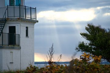Leuchtturm am Meer und Sonnenstrahlen von Martin Köbsch