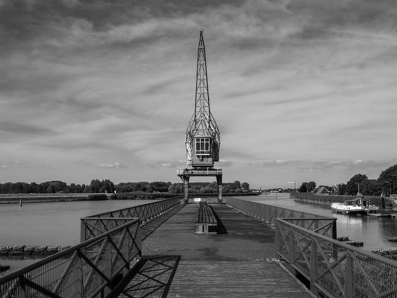 Old industrial crane with dramatic sky in black and white by Robin Jongerden