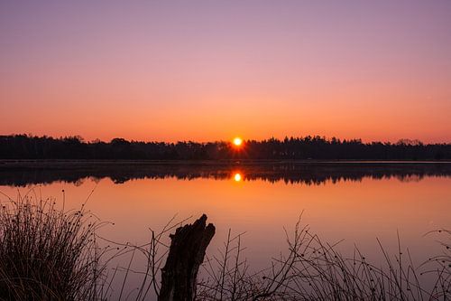Reflection in the flat water during sunrise