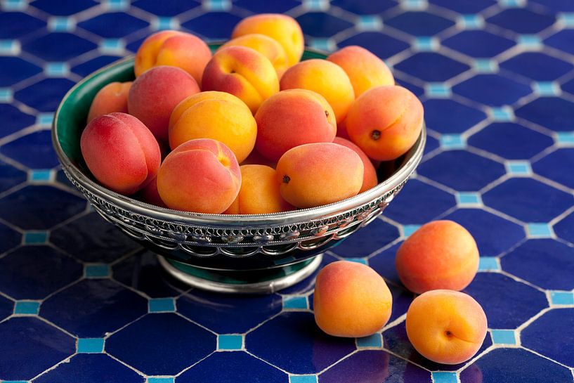 Ripe apricots in a Moroccan decorative bowl by Frans Rombout