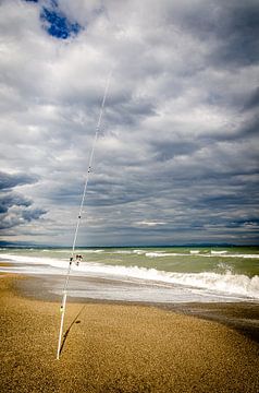 Fishing on the sand beach during thunderstorm and clouds on the Costa del Sol Andalusia Spain by Dieter Walther