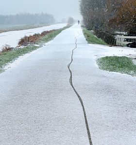 Fietser maakt spoor in de Verse Sneeuw van M DH