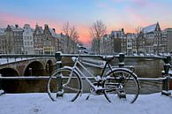 Sunset in snowy Amsterdam in the Netherlands in winter van Eye on You thumbnail