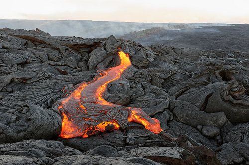 Volcanic area with red glowing lava flow on Hawaii