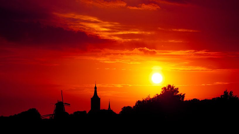Zonsondergang boven Hasselt van Karel Pops