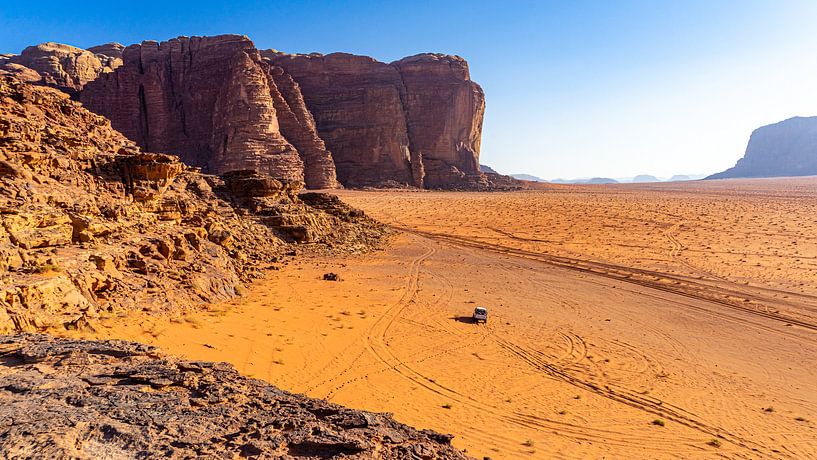 Jeep in the landscape of Wadi Rum, Jordan by Jessica Lokker