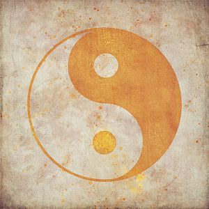 Yin-yang symbol in gold on weathered beige background