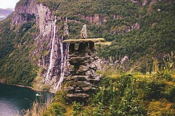 Stone hut in front of waterfall by Thomas Heitz