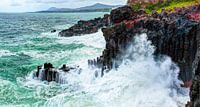Volcanic rocky coast with storming sea