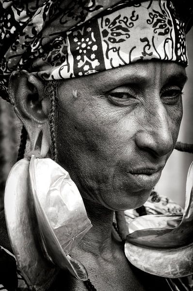 Woman with giant gold earrings! by Ton Bijvank