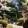 Geisha im japanischen Garten beim Rauchen einer Zigarre von Egon Zitter