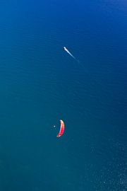 paraglider and ship over the seadark blue sea. sea-going vessel and air parapln. symbols of freedom by Michael Semenov