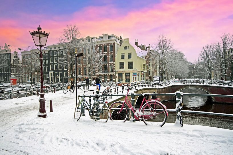 Snow-covered Amsterdam in the Netherlands in winter at sunset by Eye on You