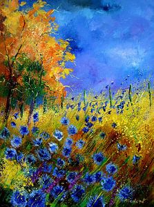 Blue cornflowers and orange trees