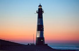 Breskens lighthouse against a pastel coloured evening sky by Moo pix